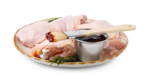 Photo of Plate with marinade, basting brush, raw chicken and rosemary isolated on white