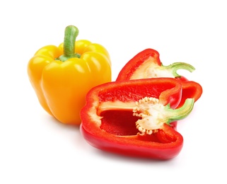 Whole and cut ripe bell peppers on white background