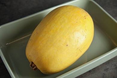 Photo of Baking dish with spaghetti squash on gray table