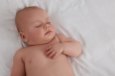 Photo of Cute newborn baby sleeping on bed, top view