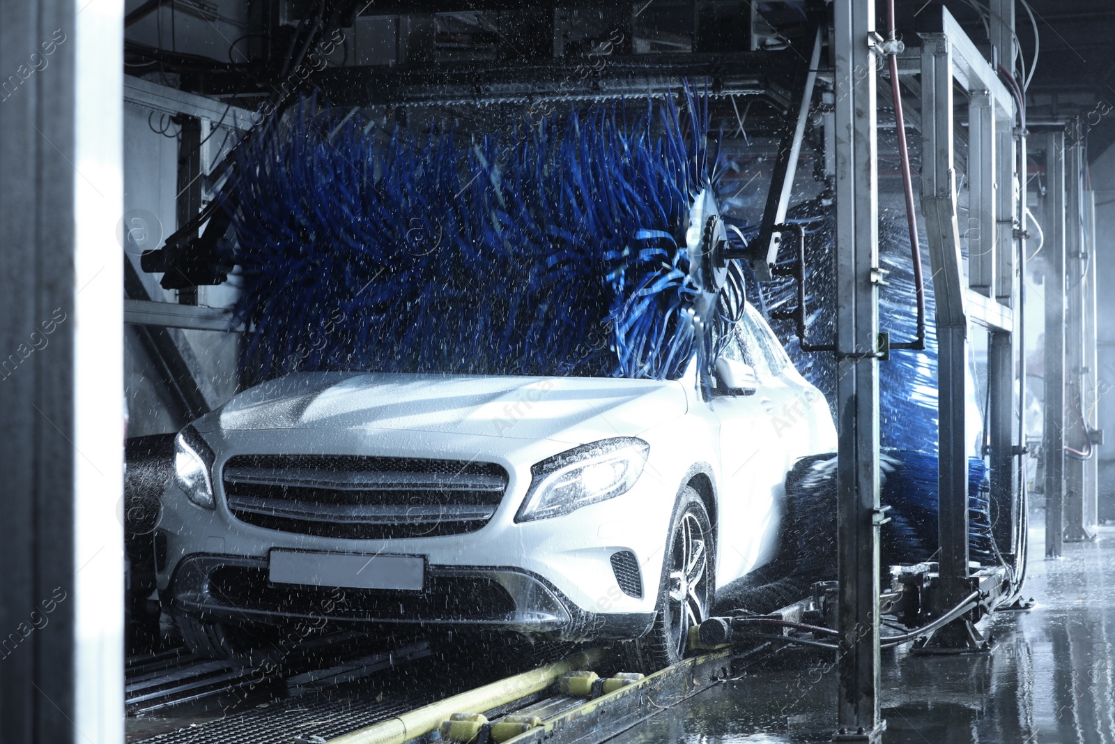 Photo of Modern auto undergoing cleaning at car wash