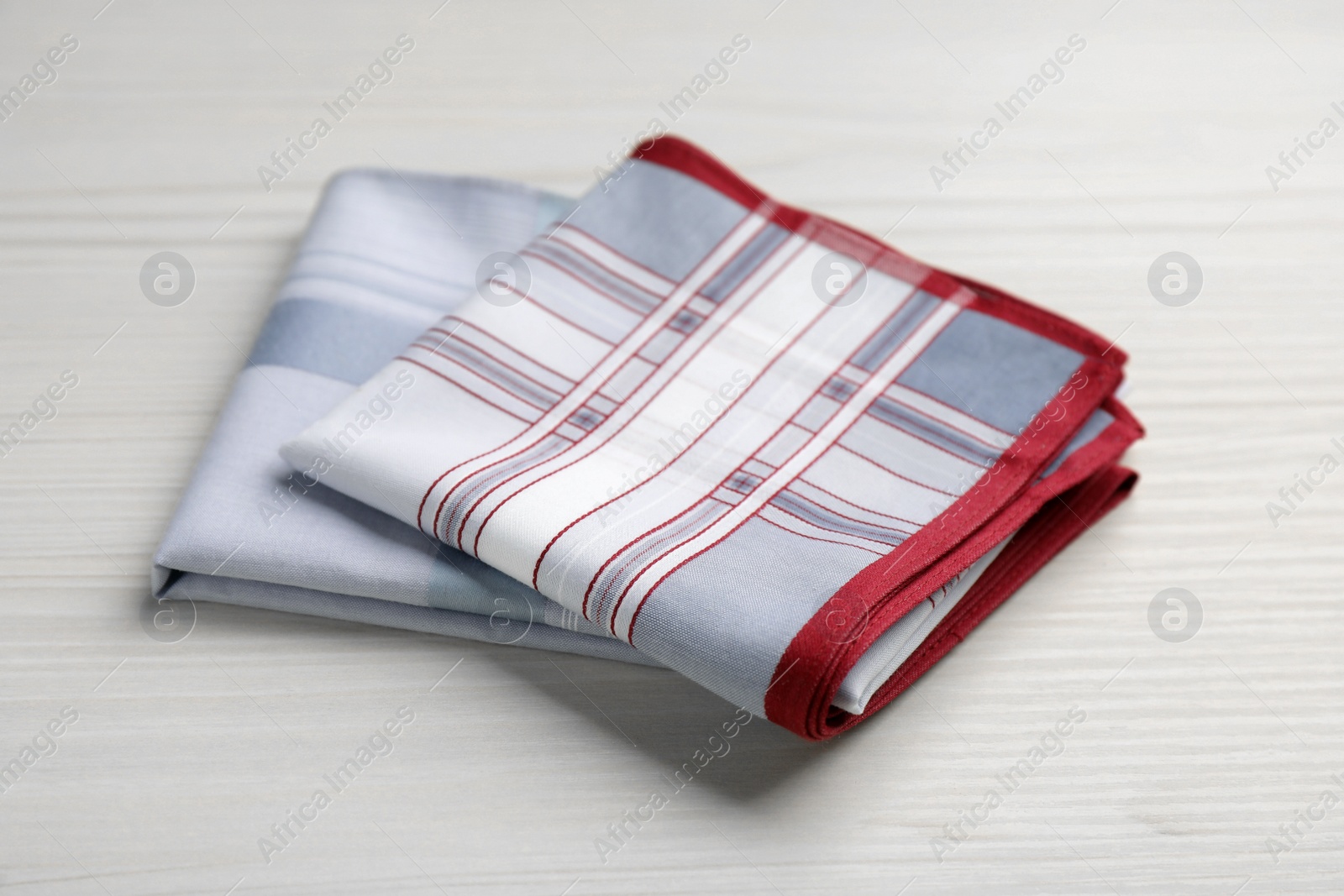 Photo of New stylish handkerchiefs on white wooden table