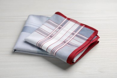 New stylish handkerchiefs on white wooden table