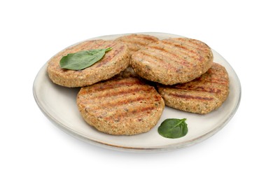 Plate of delicious grilled vegan cutlets and spinach isolated on white