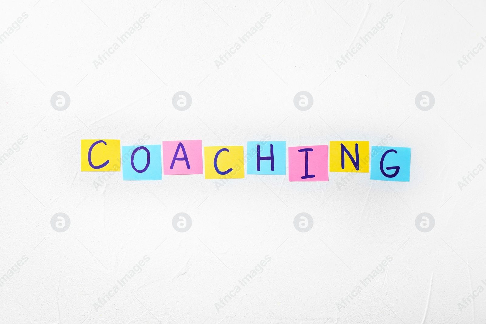 Photo of Word "Coaching" on white background. Business trainer concept