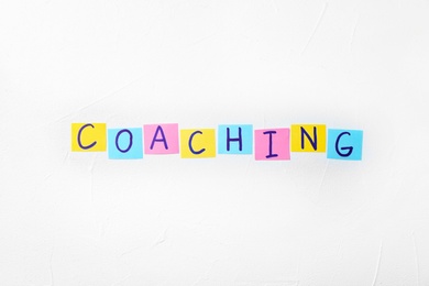 Photo of Word "Coaching" on white background. Business trainer concept