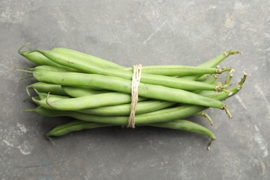 Photo of Fresh green beans on grey table, top view