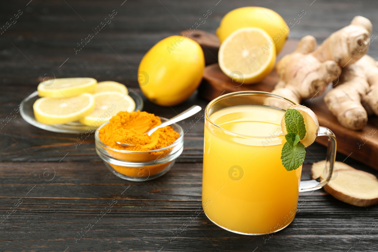 Photo of Immunity boosting drink and ingredients on dark wooden table. Space for text