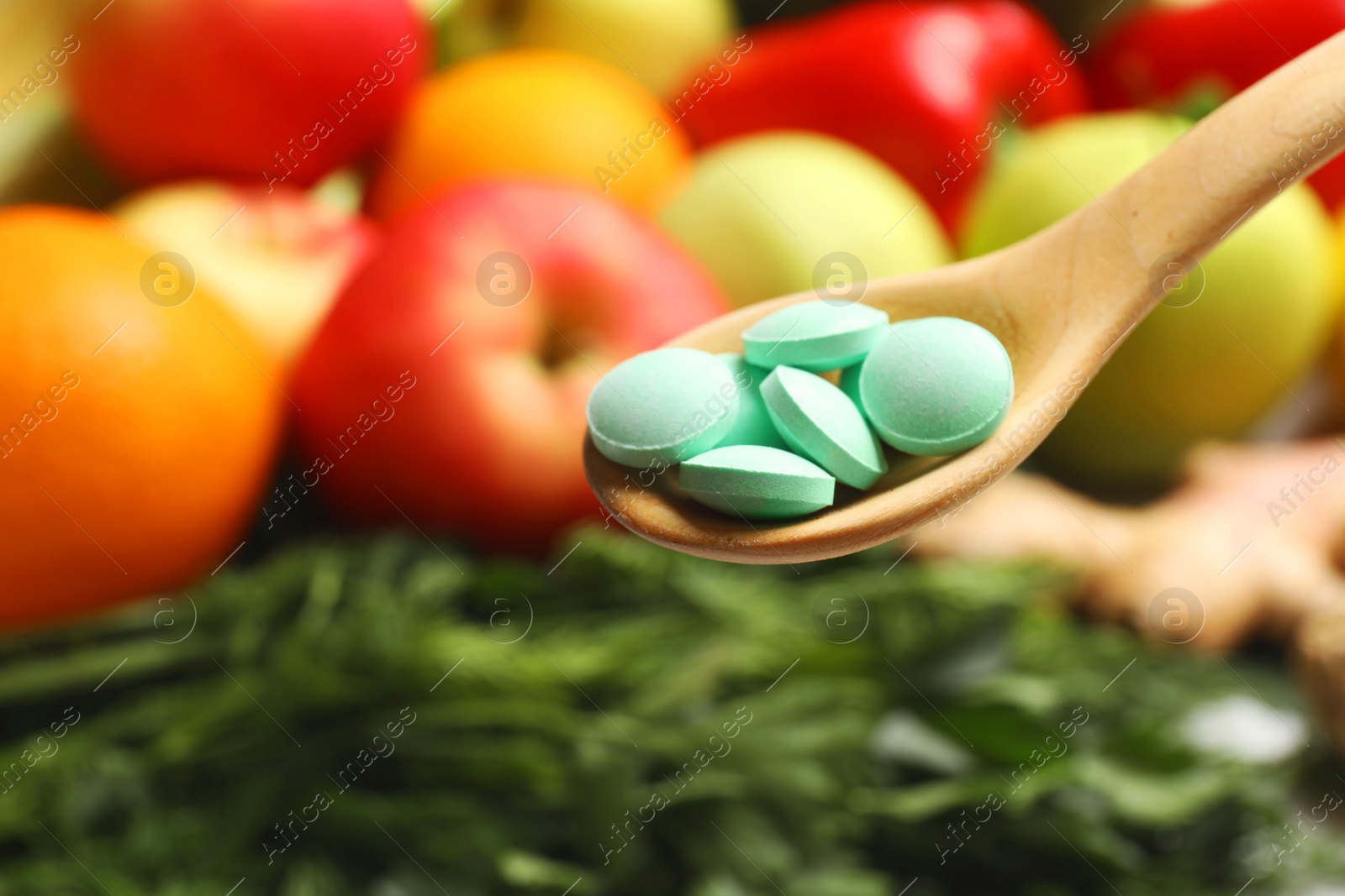 Photo of Dietary supplements in wooden spoon near products, closeup. Space for text