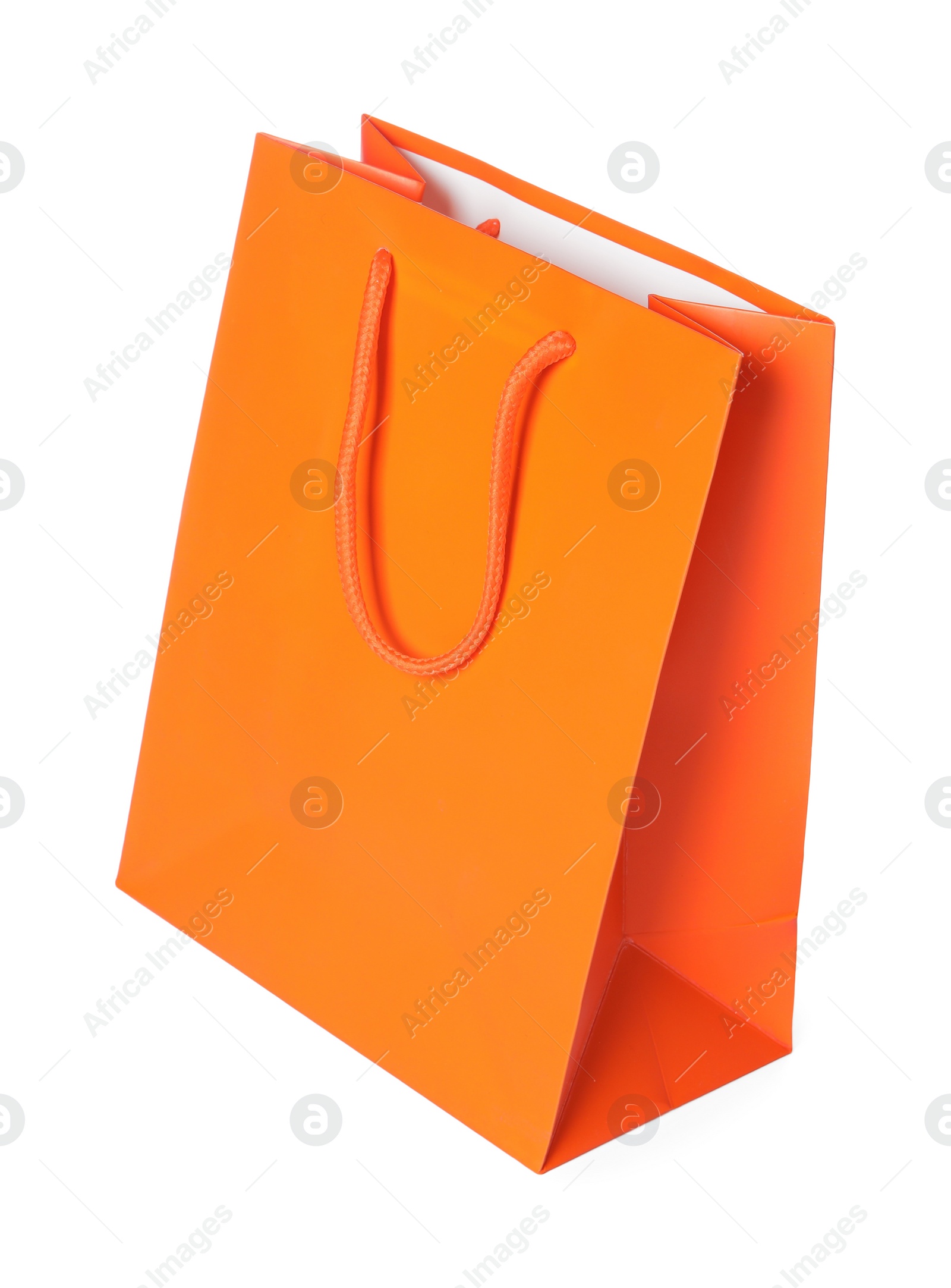 Photo of One orange shopping bag isolated on white