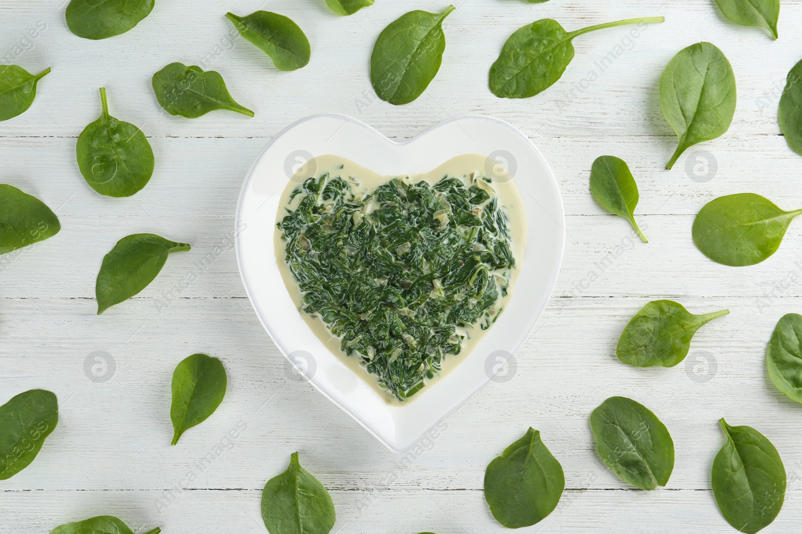 Photo of Flat lay composition with tasty spinach dip on white wooden table