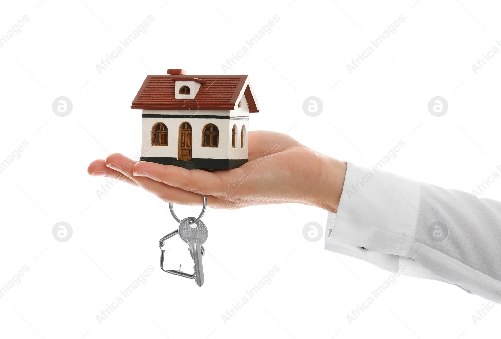 Photo of Real estate agent holding house model and key on white background, closeup