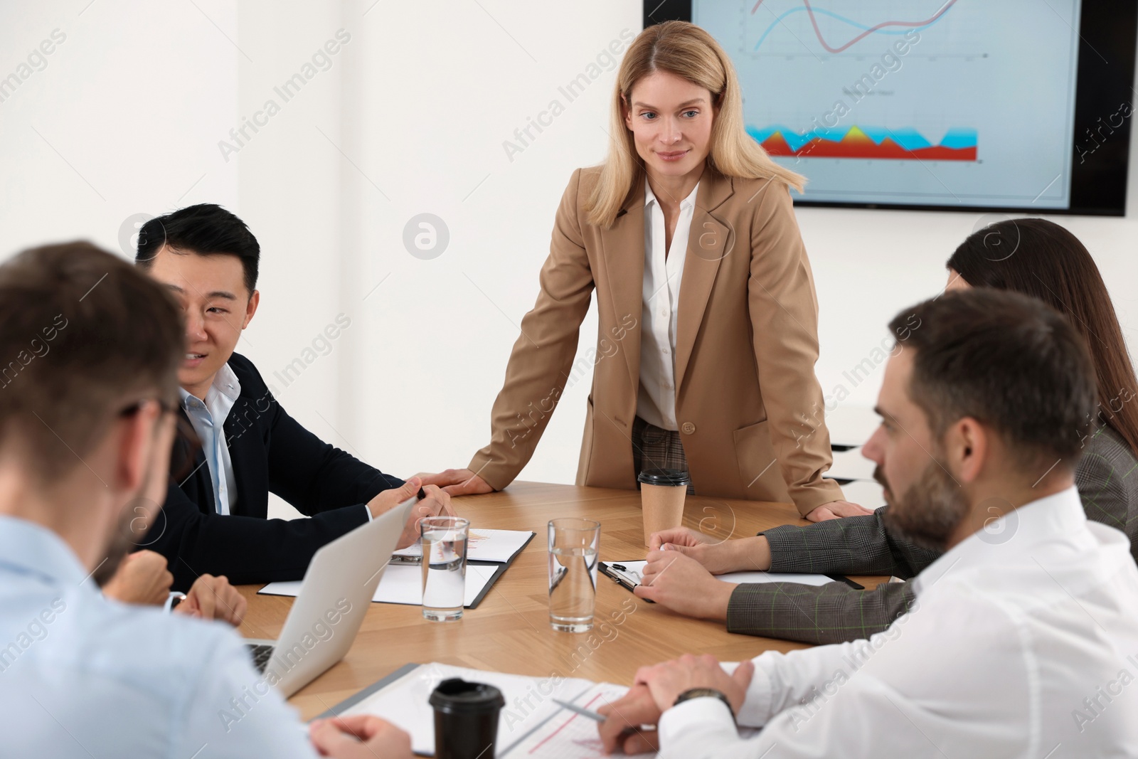 Photo of Businesswoman having meeting with her employees in office