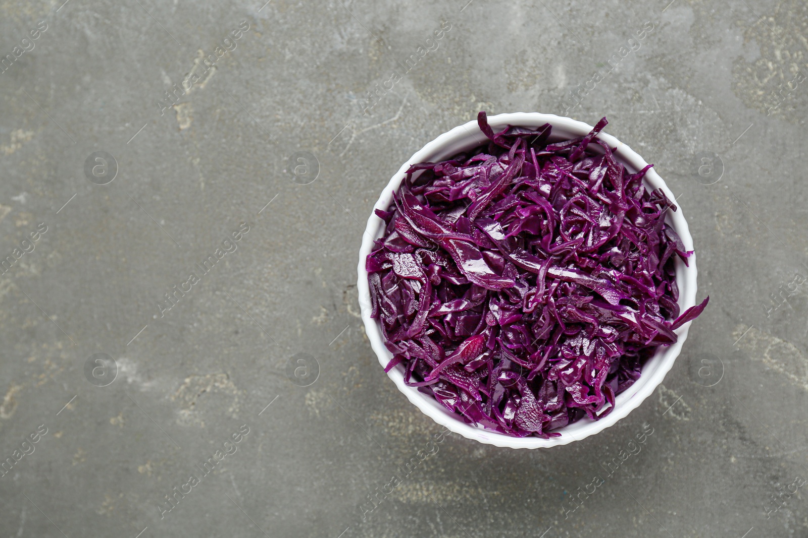 Photo of Tasty red cabbage sauerkraut on light grey table, top view. Space for text