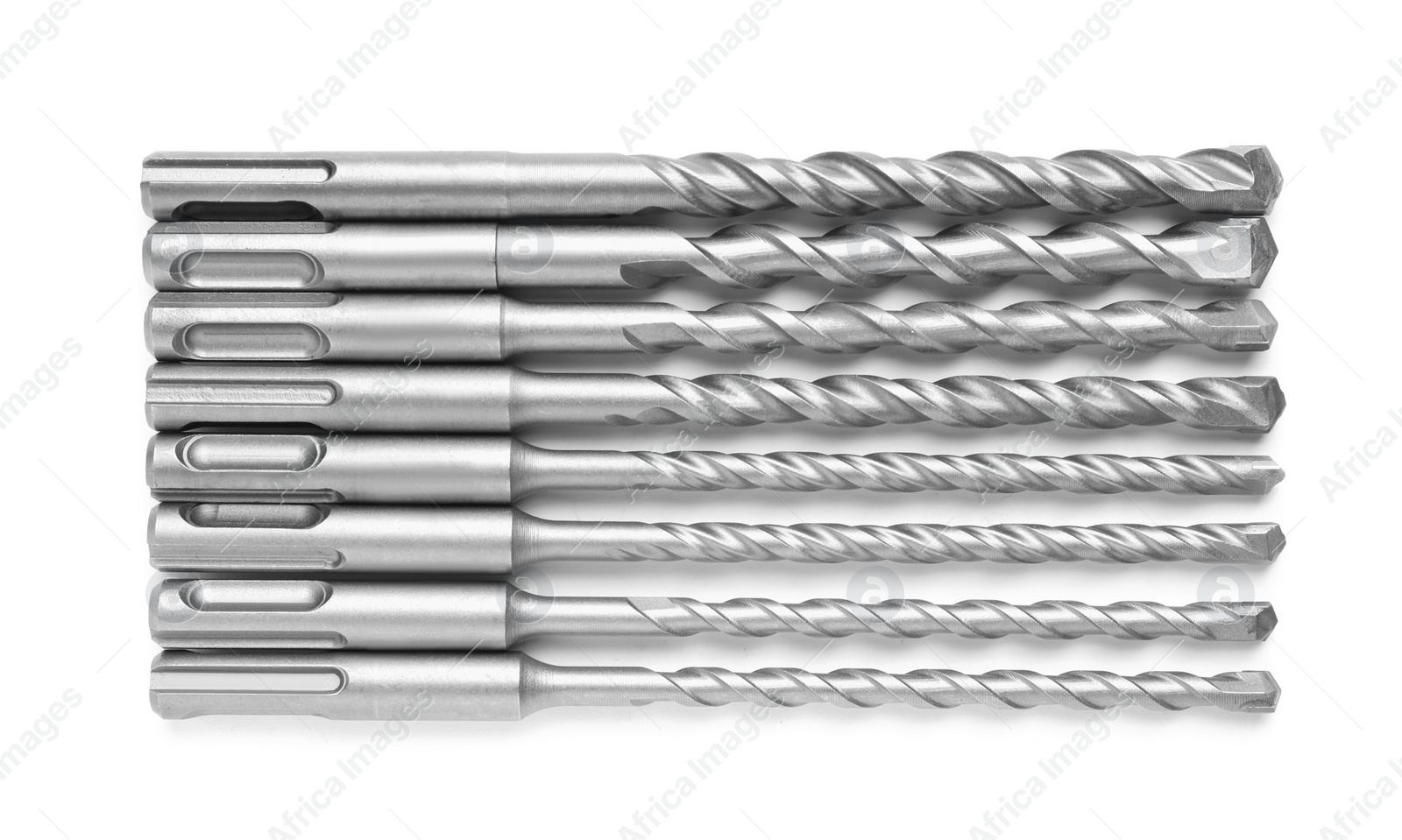 Photo of Many twist drill bits isolated on white, top view. Carpenter's tools