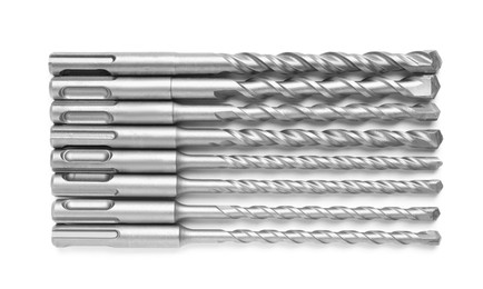 Photo of Many twist drill bits isolated on white, top view. Carpenter's tools