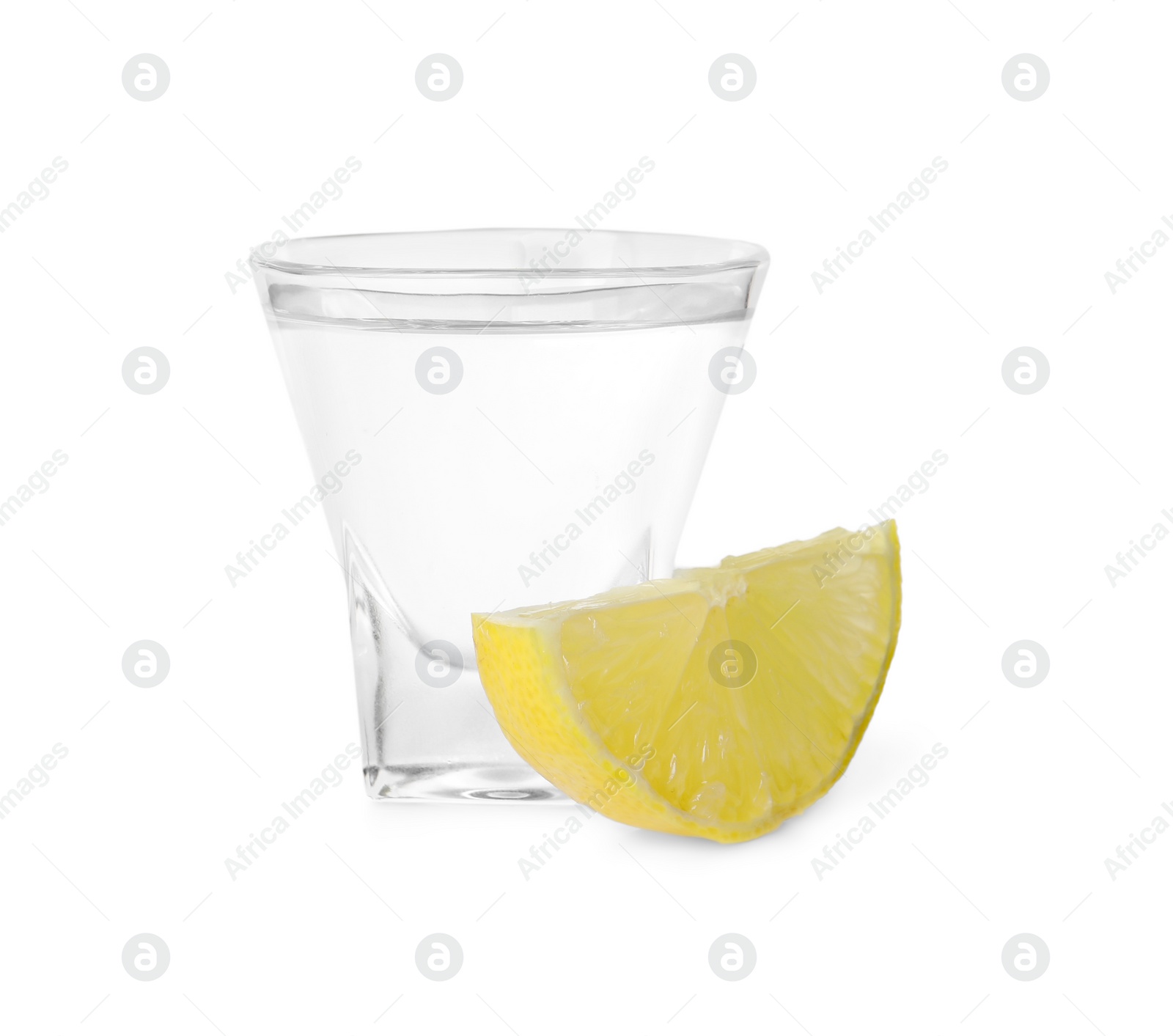 Photo of Shot glass of vodka and lemon isolated on white