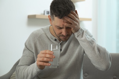 Photo of Man taking medicine for hangover at home
