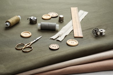 Photo of Different sewing supplies and accessories on fabric