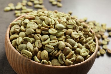 Photo of Green coffee beans on grey table, closeup
