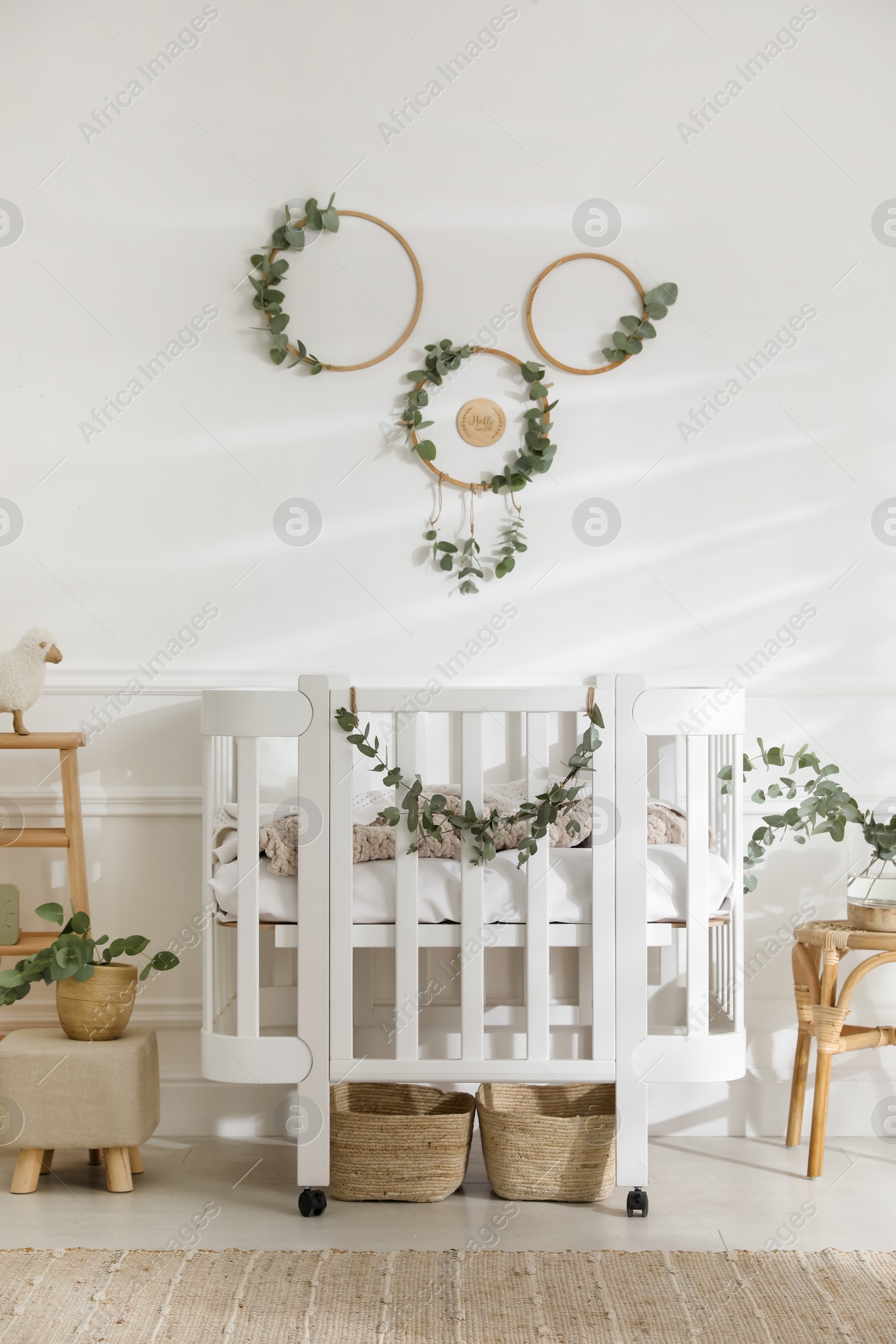 Photo of Stylish baby room decorated with eucalyptus branches