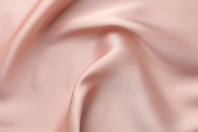 Photo of Crumpled pink silk fabric as background, top view