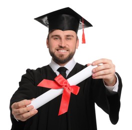 Photo of Happy student with graduation hat against white background, focus on diploma