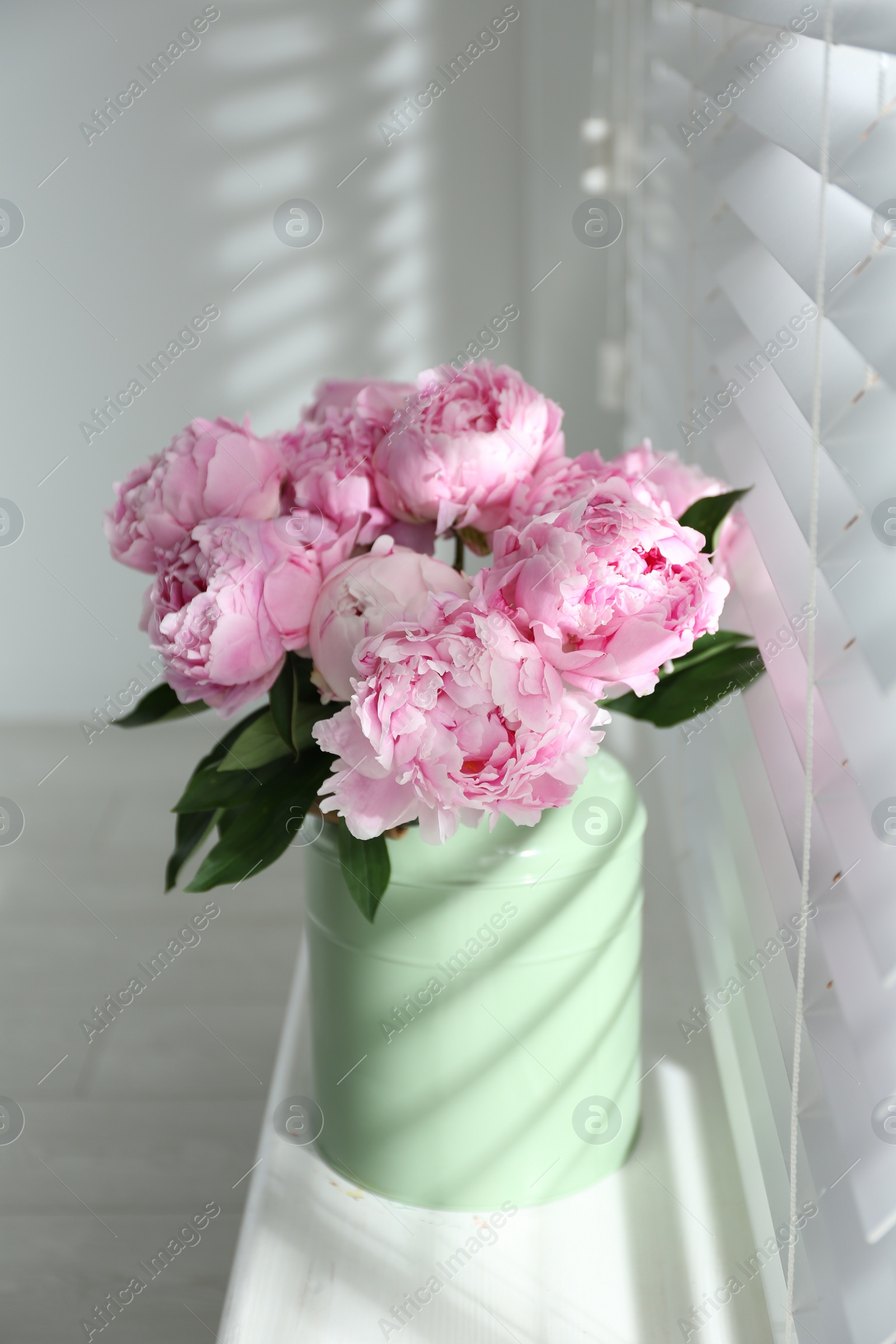 Photo of Bouquet of beautiful peonies on window sill