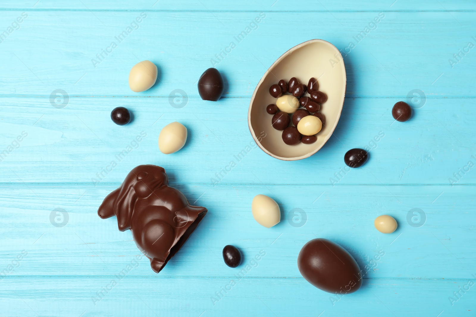 Photo of Flat lay composition with chocolate Easter eggs on wooden background