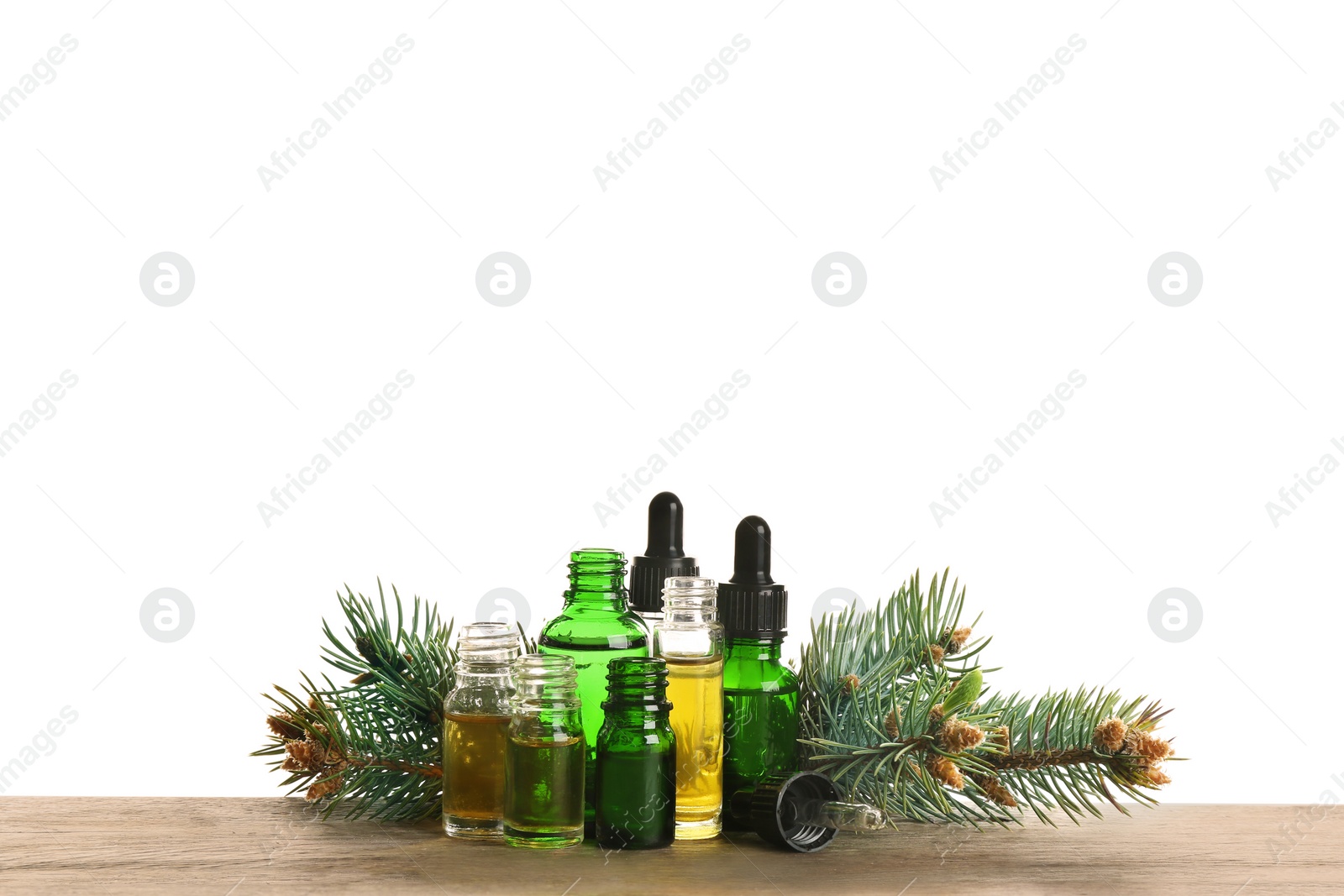 Photo of Composition with bottles of conifer essential oil on table against white background. Space for text