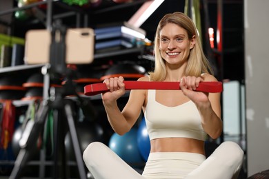 Fitness trainer recording online classes in gym