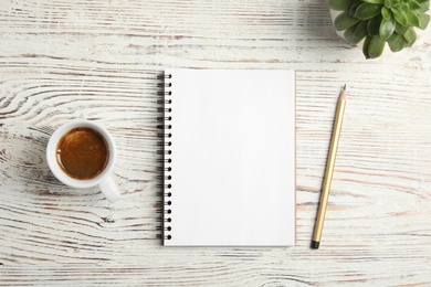 Photo of Flat lay composition with notebooks and coffee on wooden background