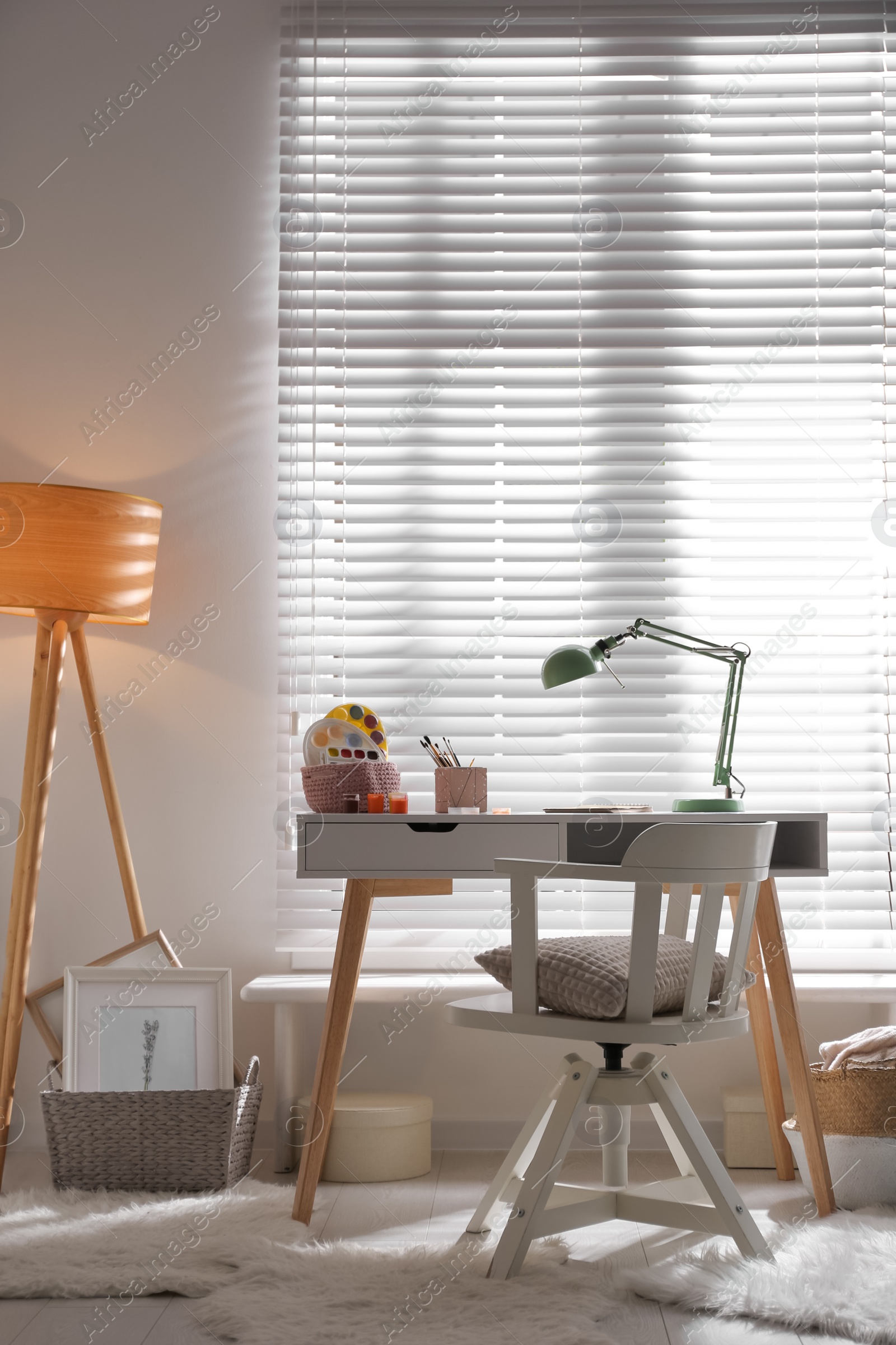 Photo of Stylish room interior with comfortable workplace near window