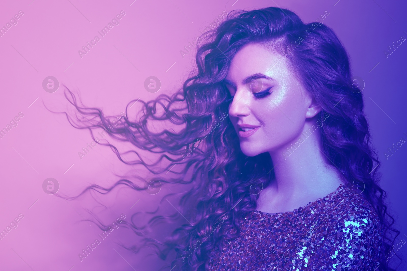 Image of Portrait of beautiful woman in neon lights