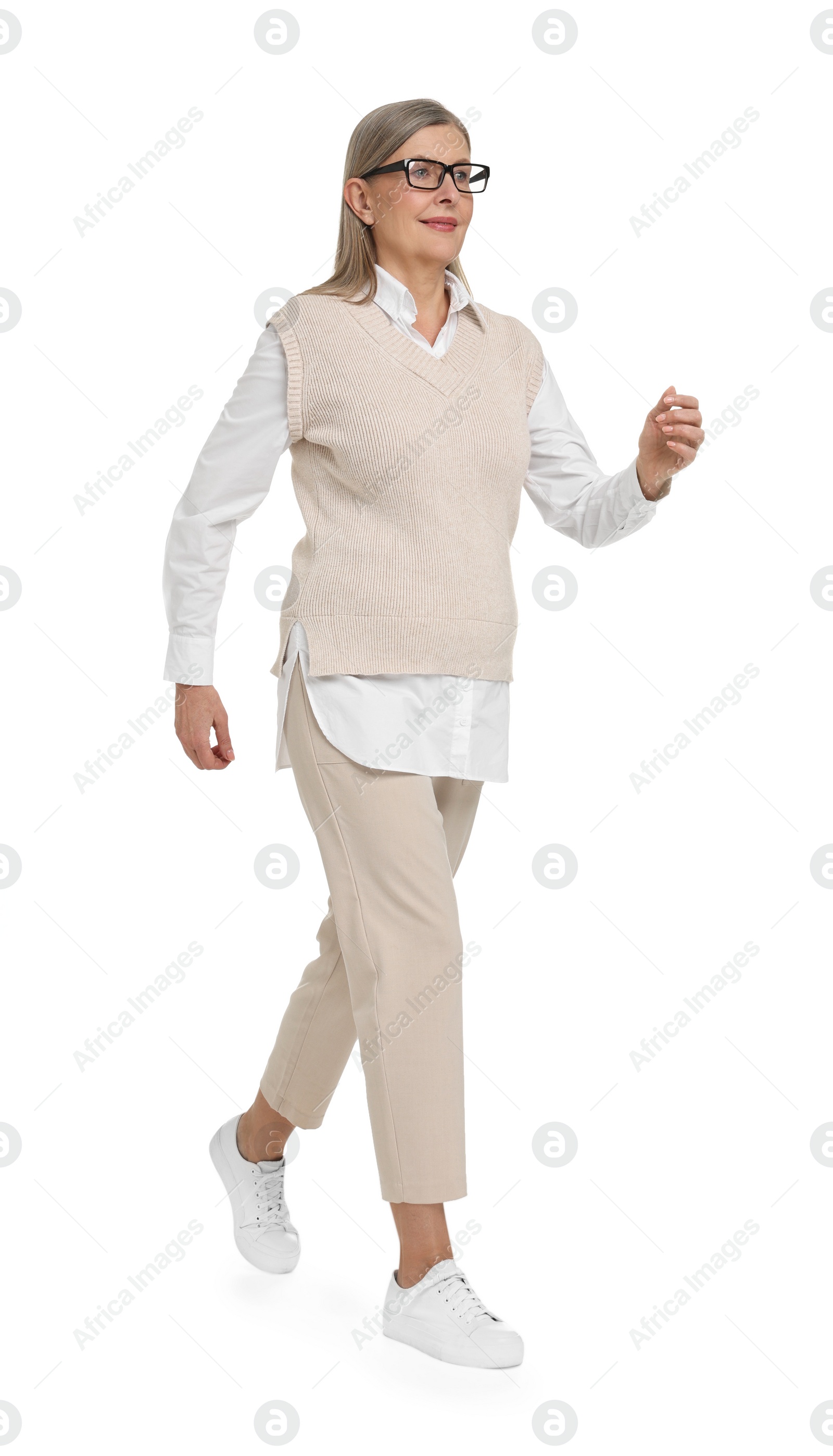Photo of Senior woman in glasses walking on white background