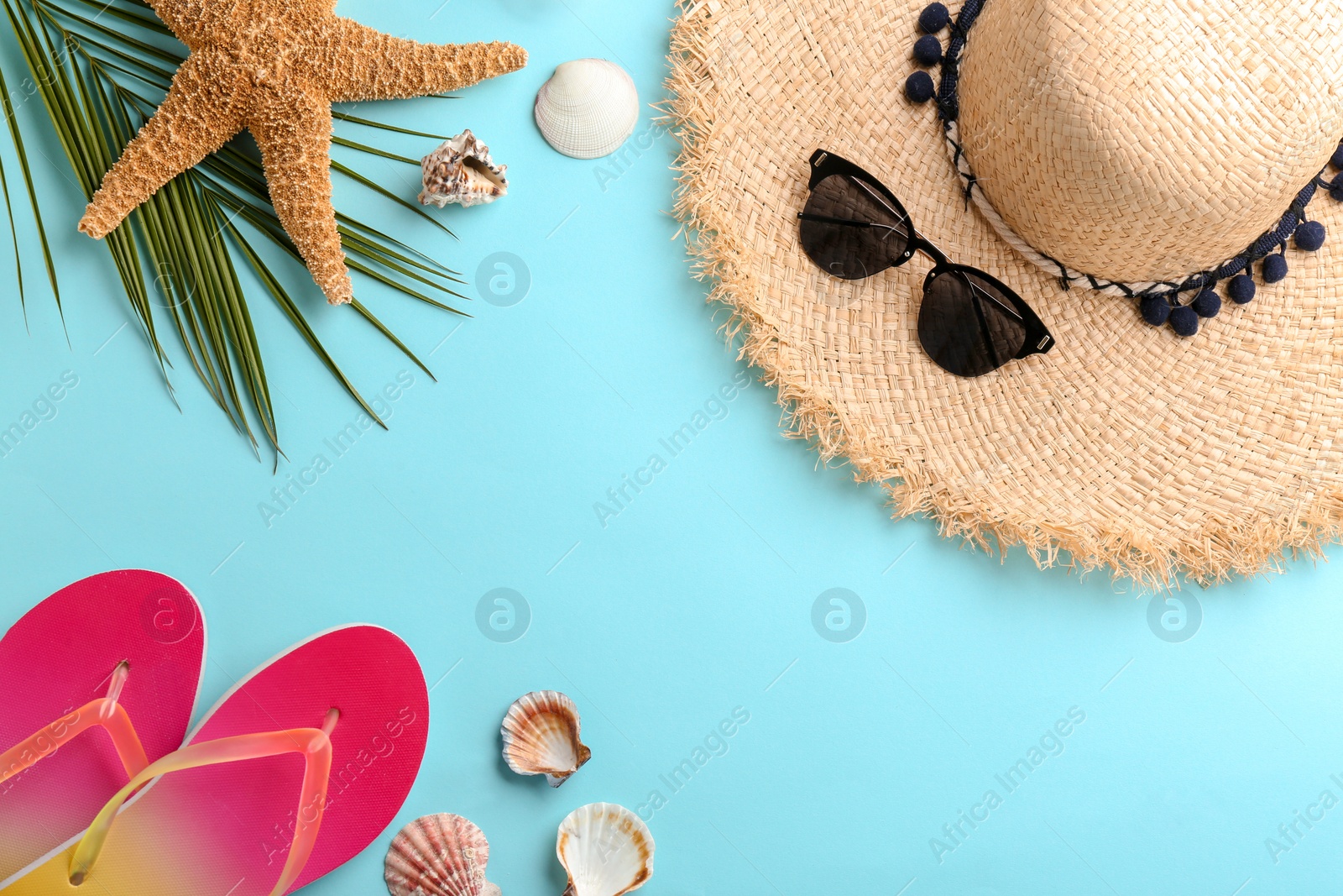 Photo of Flat lay composition with stylish hat and beach objects on color background