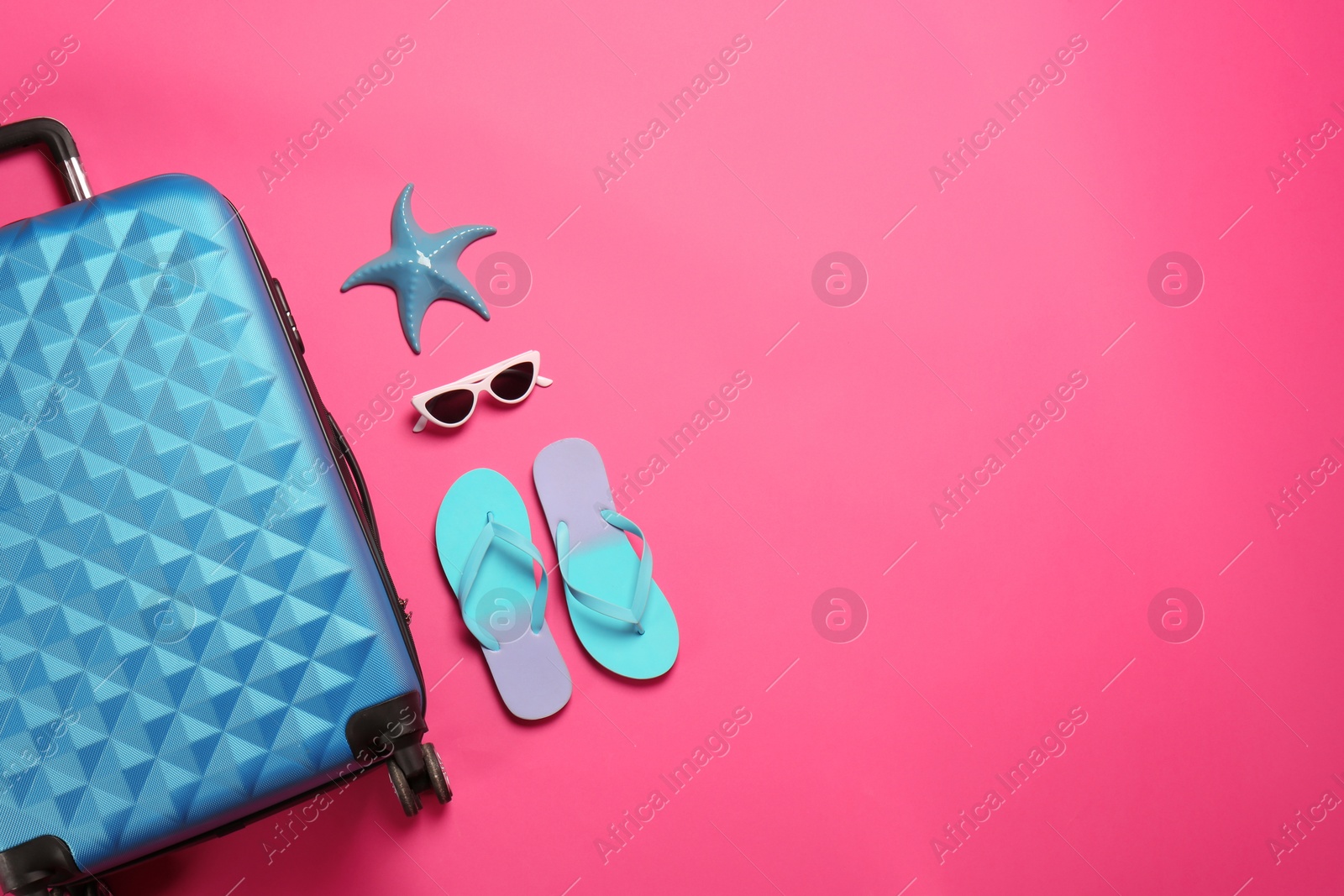 Photo of Flat lay composition with suitcase and beach items on color background. Space for text