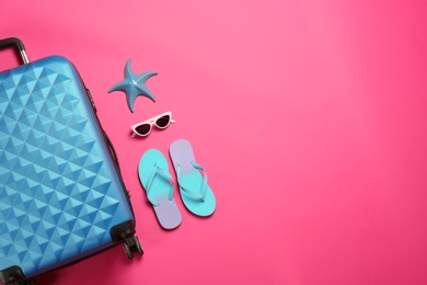 Photo of Flat lay composition with suitcase and beach items on color background. Space for text