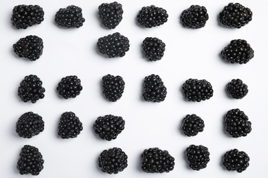 Flat lay composition with ripe blackberries on white background