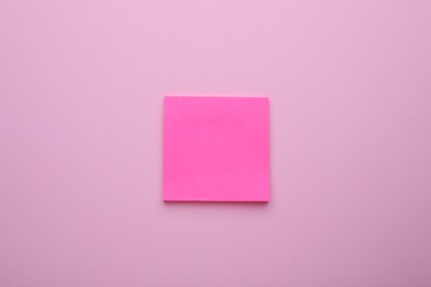 Photo of Paper note on pale pink background, top view