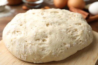 Board with wheat dough for pastries, closeup