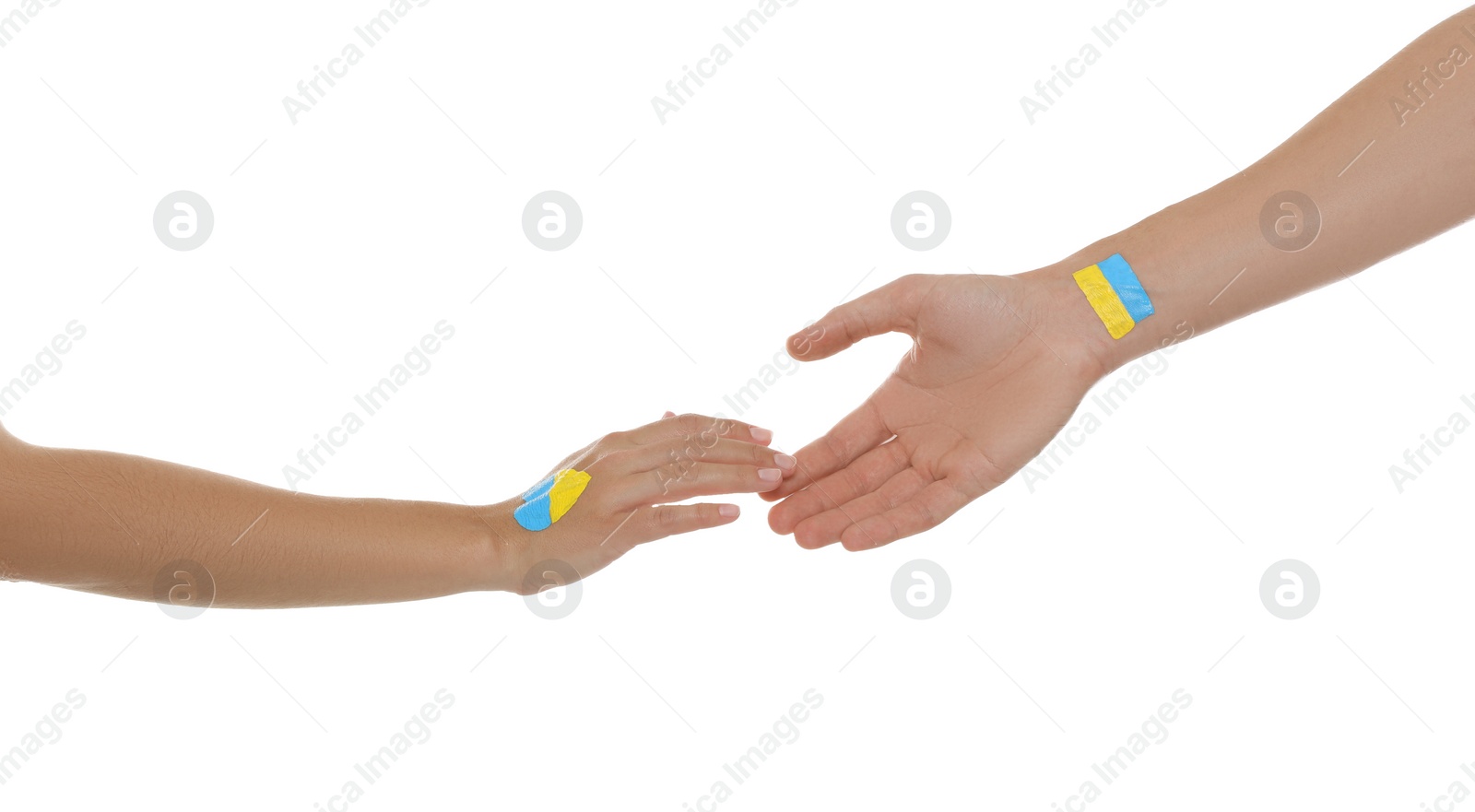 Photo of Man and woman with painted Ukrainian flags on their hands against white background, closeup