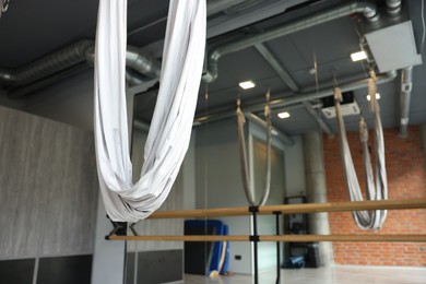 Photo of Many hammocks for fly yoga in studio, space for text