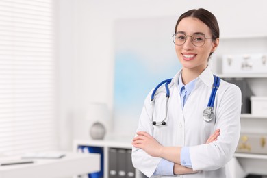 Photo of Medical consultant with glasses and stethoscope in clinic, space for text