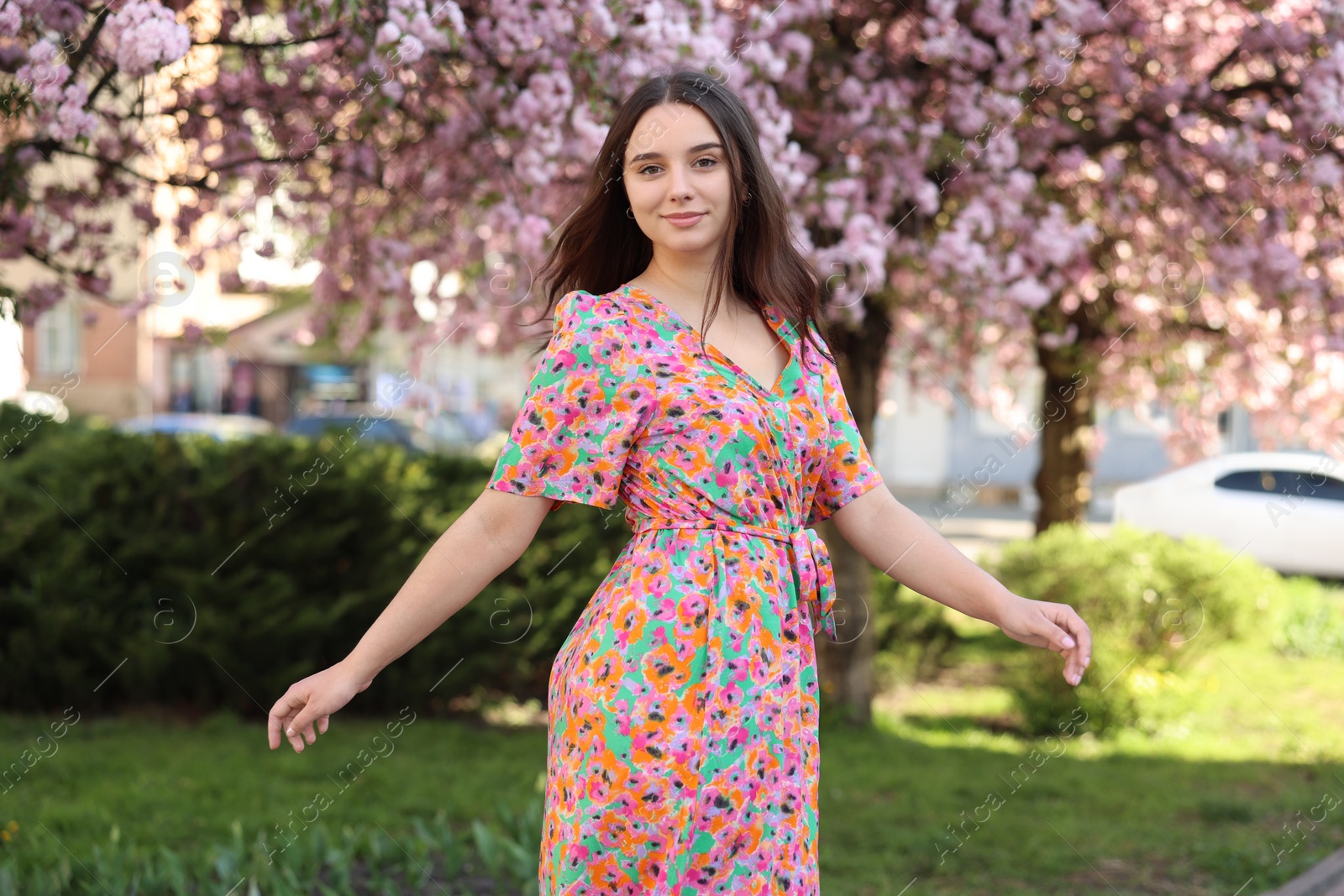 Photo of Beautiful woman near blossoming trees on spring day