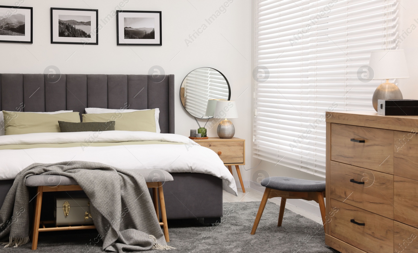 Photo of Window with horizontal blinds and comfortable bed in room