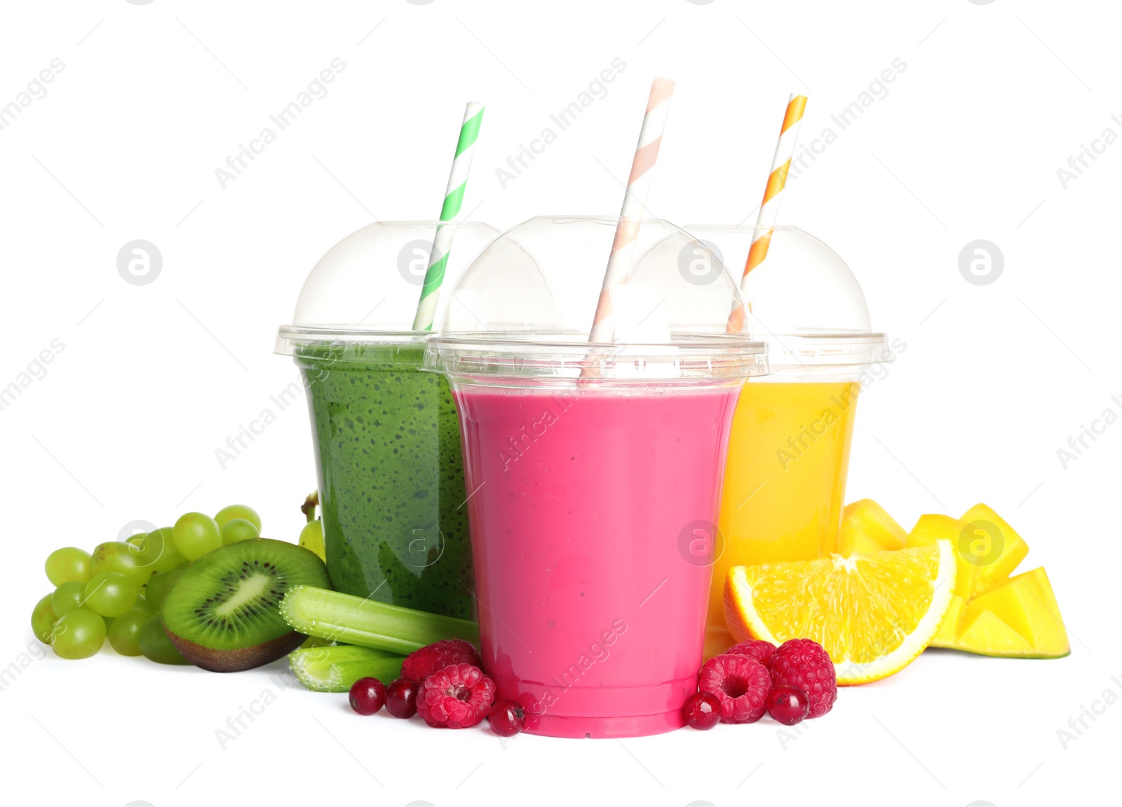 Photo of Plastic cups with delicious smoothies and ingredients on white background