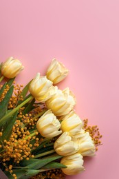 Bouquet with beautiful tulips and mimosa flowers on pink background, top view. Space for text