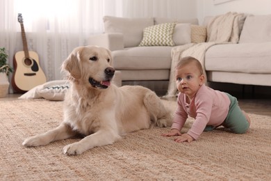 Cute little baby with adorable dog on floor at home