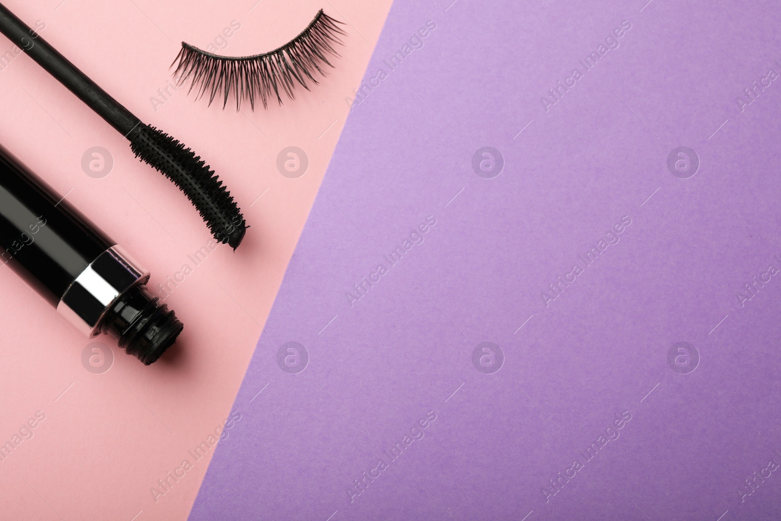 Photo of Mascara and artificial eyelashes on color background, flat lay with space for text